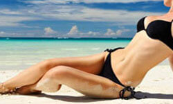 Picture of a girl on a beach showing her trimmed abdomen.