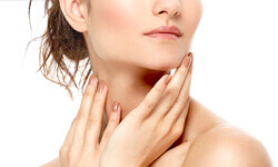 An angled view picture of a woman pleased with her neck lift procedure.