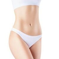 Picture of a woman in a two piece bathing suit, showing the tummy tuck with abdomen liposuction she had in Costa Rica.