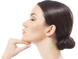 Close-up side-view portrait picture of a beautiful woman’s face, showing the ear correction procedure she had in Costa Rica.