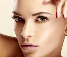 Close-up portrait picture of a beautiful woman’s face, showing the forehead brow lift procedure she had in Costa Rica.