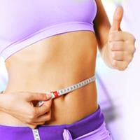 Picture of a woman holding a tape measure around her waist showing the results of the gastric bypass procedure she had in Costa Rica.