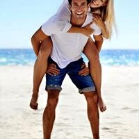 Picture of a happy couple standing on the beach