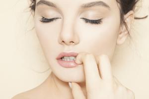 Close-up picture of woman’s face showing the lip reduction procedure she had in Costa Rica.