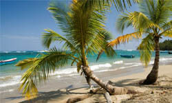 Picture of a beautiful Costa Rica beach with waves breaking on a sandy shore.