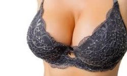 Picture of a woman wearing a blue designer bra depicting her recent breast enhancement procedure she had in Costa Rica.