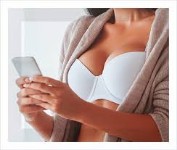 Picture of a woman’s with an arm over her breasts showing the results of her breast lift along with a breast reduction she had in Costa Rica.