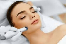 Picture of a woman lying down being administered a dermabrasion procedure she had in Costa Rica.