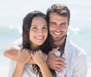 Picture of a man and woman hugging each other and illustrating a hair micrographs transplant procedure he had in Costa Rica.