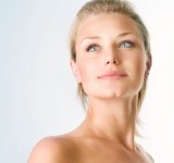 A front view picture of a woman pleased with her neck lift procedure she had in Costa Rica..