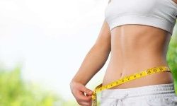 Front view photo of a woman wearing a two piece outfit illustrating her weight loss with an obesity treatment she had in Costa Rica.