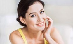 Portrait picture of a smiling woman showing her happiness with her seborrhea Keratosis treatment