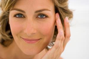 Close-up picture of a woman’s face showing a laser sun damage procedure.