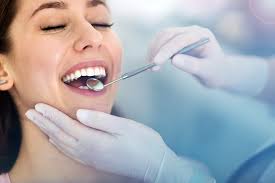 Picture of a smiling woman in a dental chair showing her happiness with the holistic dentistry procedure she is receiving.