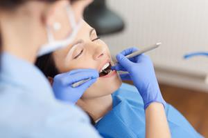 Picture of a woman sitting in a dental chair displaying the holistic full mouth rehabilitation dental procedure she is having in Costa Rica.