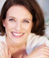 Picture of a smiling woman showing her happiness with the oral and maxillofacial procedure she received in Costa Rica.