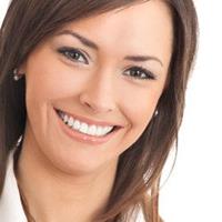 Picture of a smiling woman displaying the pure porcelain veneers procedure she had in Costa Rica.